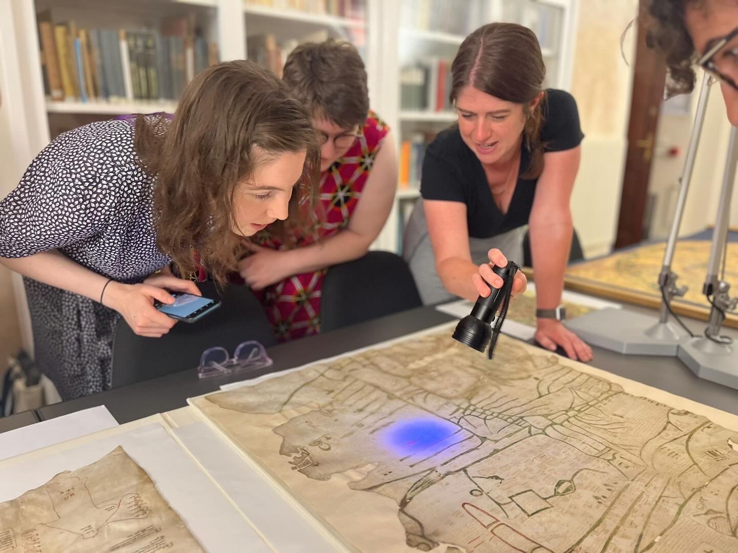 Davies and students studying a map