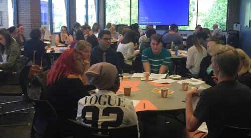 An image of many students collaborating at an English Workshop